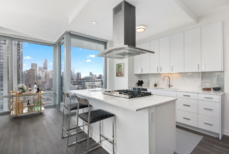 Apartments at The Sinclair feature kitchens inspired by Mick DeGiulio and breathtaking skyline views from floor-to-ceiling windows.